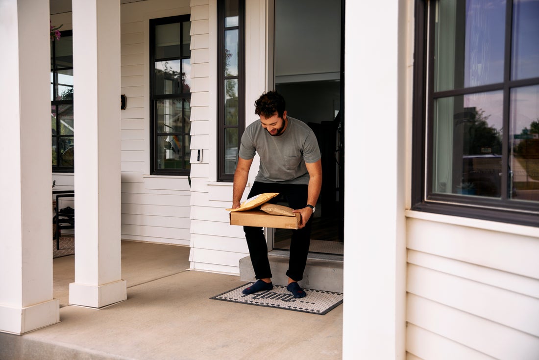 Man receives package from his doorstep after his Vivint system notified him of delivery