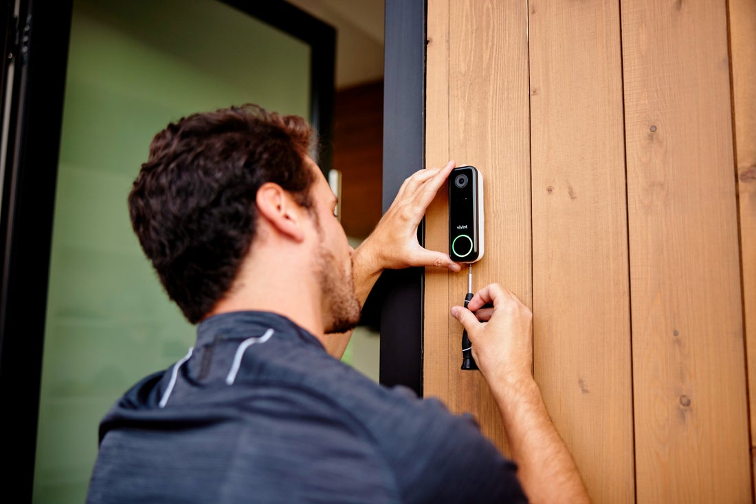 A Vivint technician installing the Vivint Doorbell Camera Pro