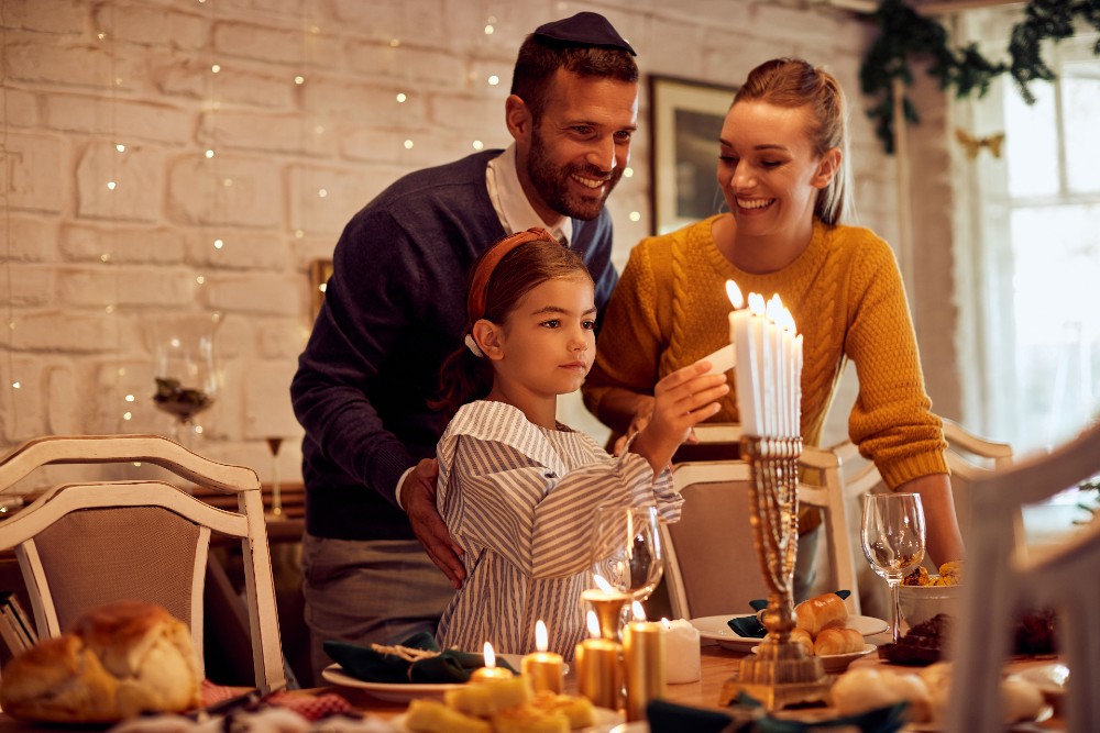 family lighting the Menorah