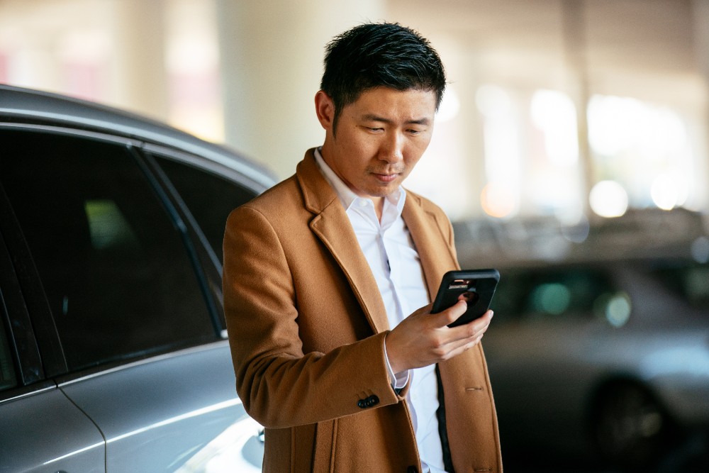 Man recording where his car is with Car Guard in the Vivint app.