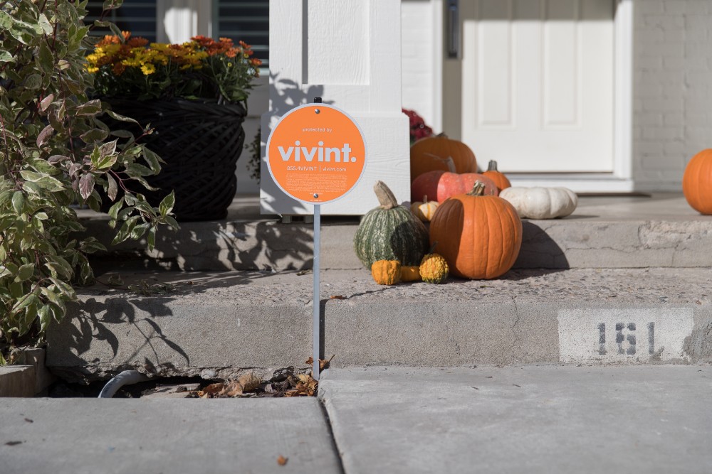 Vivint porch sign on a fall porch decorated with pumpkins.