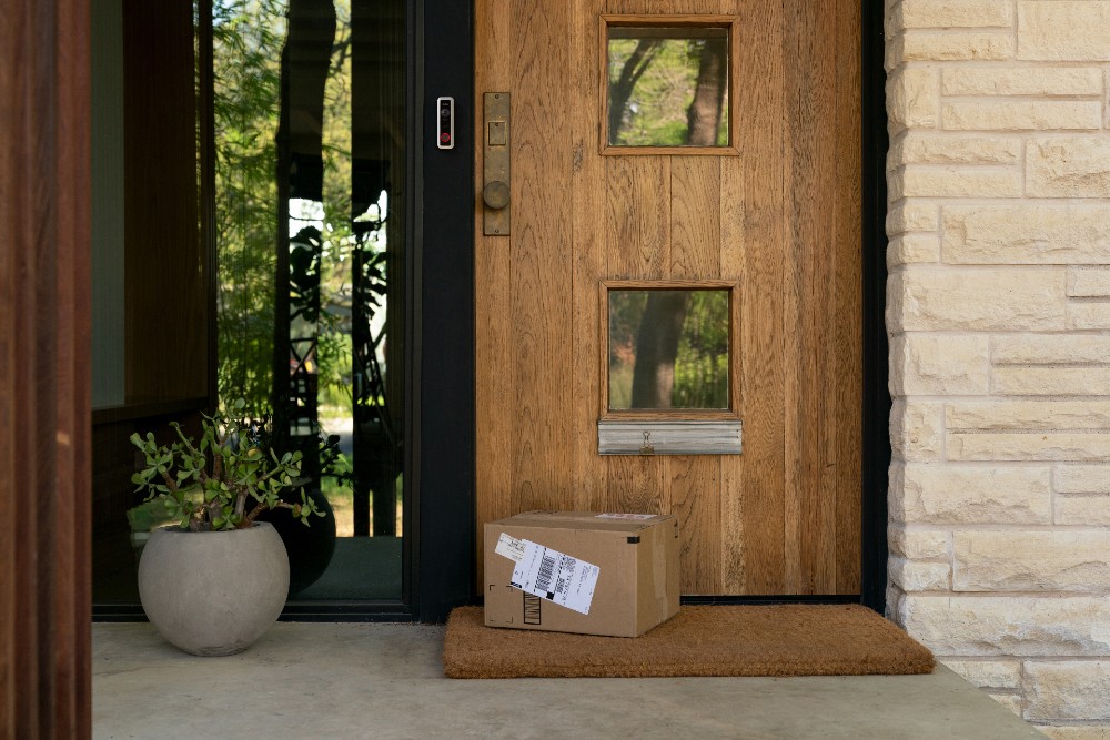 Vivint Doorbell Camera monitoring packages on a front porch.