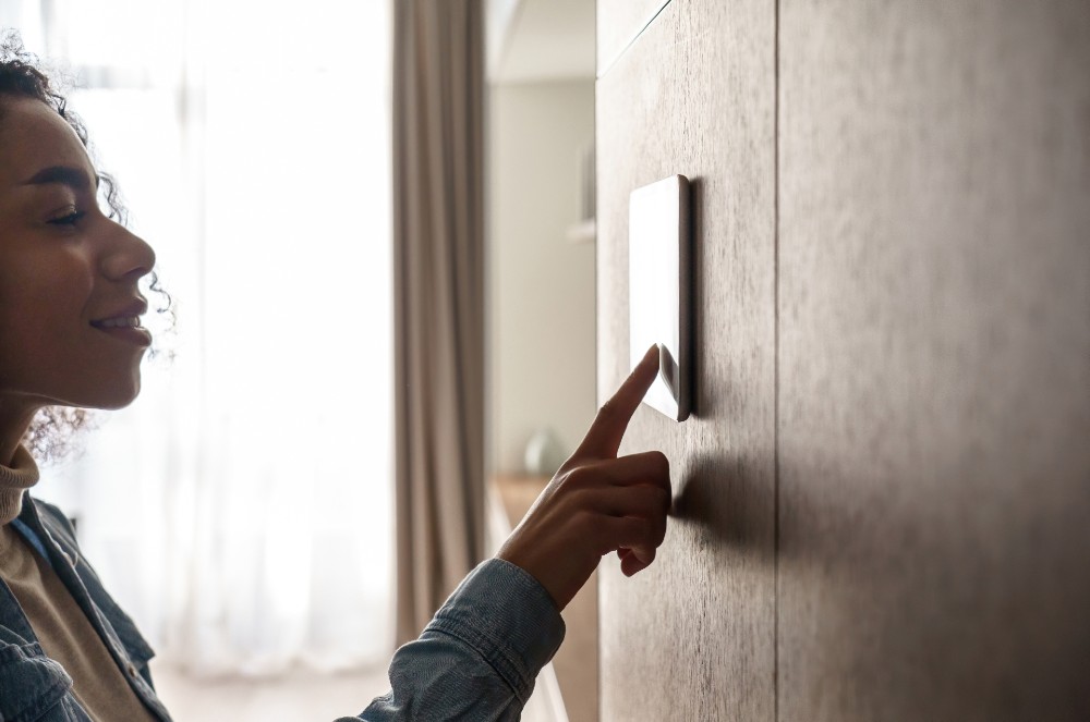 Woman arming her apartment alarm system.