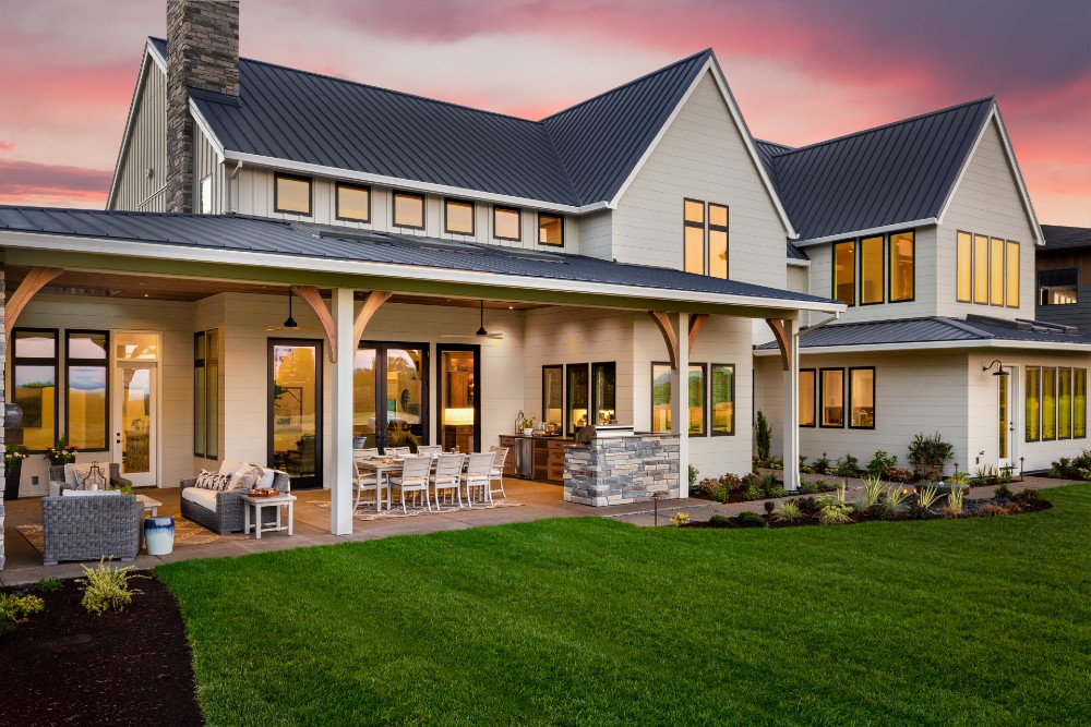 Exterior of a home lit up at night by outdoor security lighting.