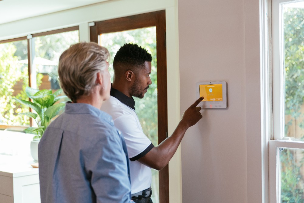 Vivint installer showing a customer how to work their system.