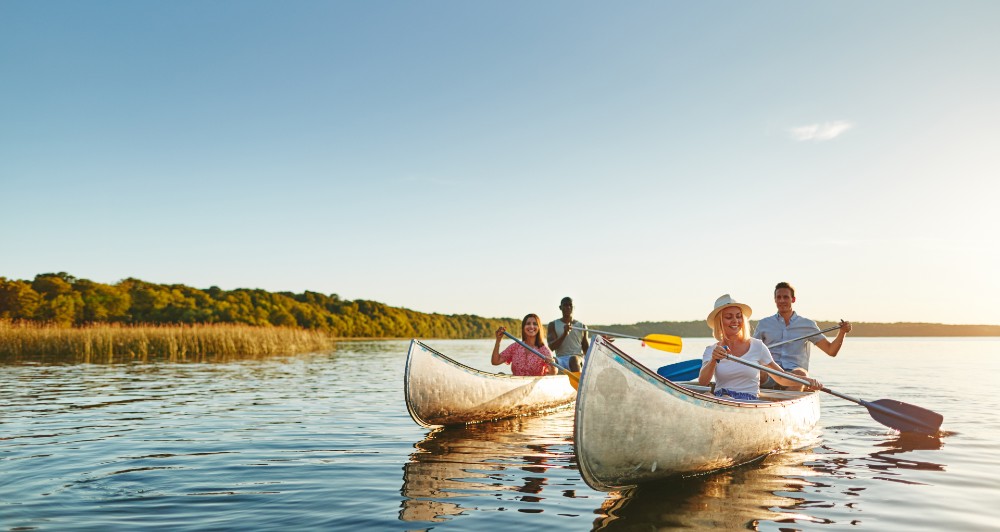 Friends kayaking on a lake.