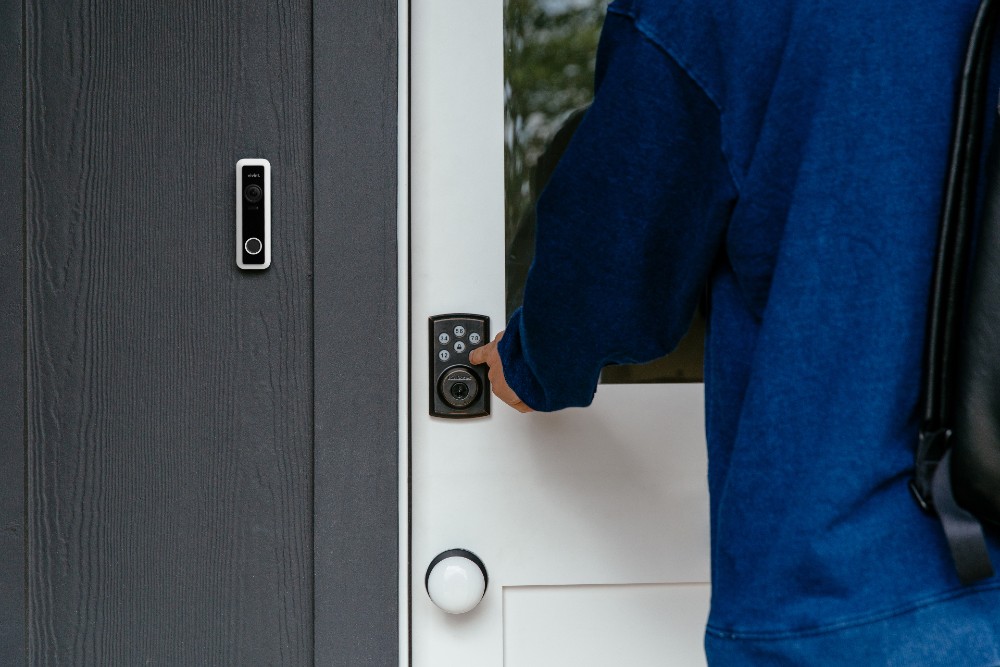 Person unlocking their smart door lock.
