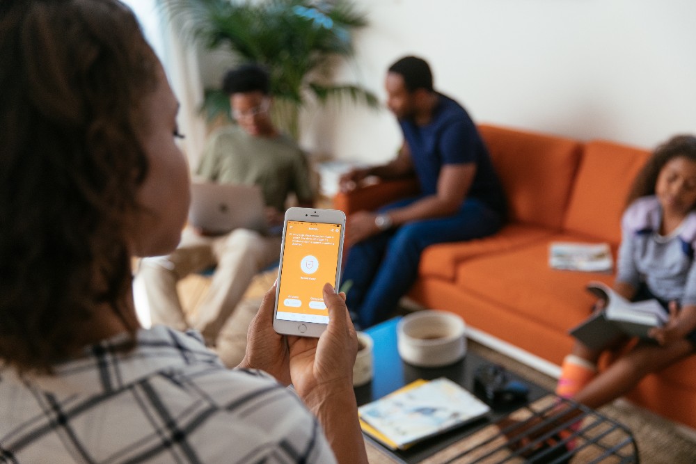 Woman checking the Vivint App on her phone.