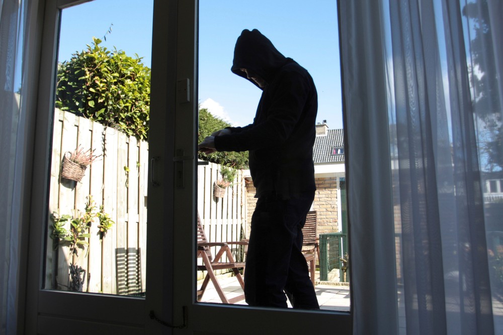 Lurker looking inside a home's windows.