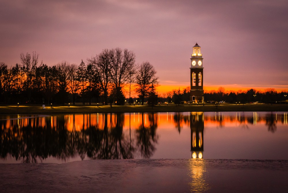 Bell tower and lake at Coxhall Garden in Carmel Indiana at sunset in winter