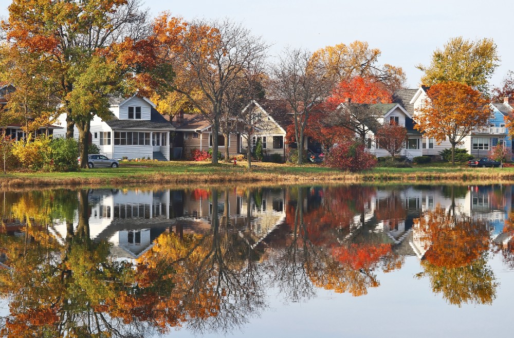 Fall cityscape with a private neighborhood along a pond