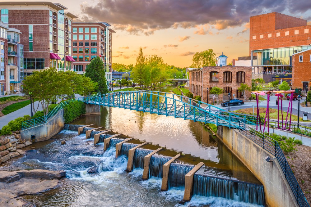 Greenville South Carolina downtown cityscape on the Reedy River at dusk