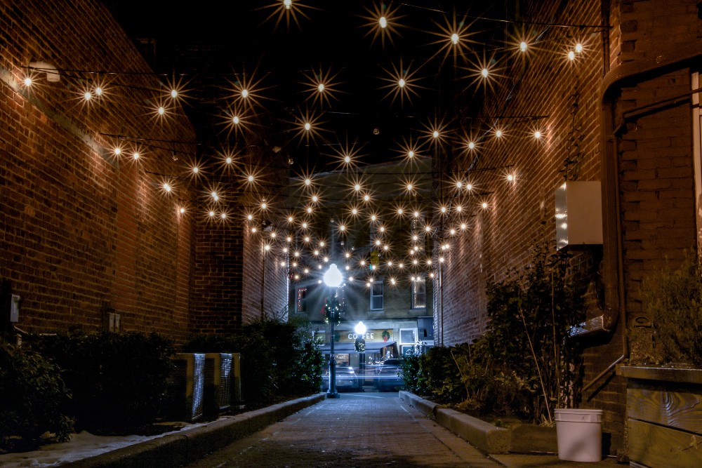 Electric lights hanging over alley in front of coffee shop in Cranford, New Jersey