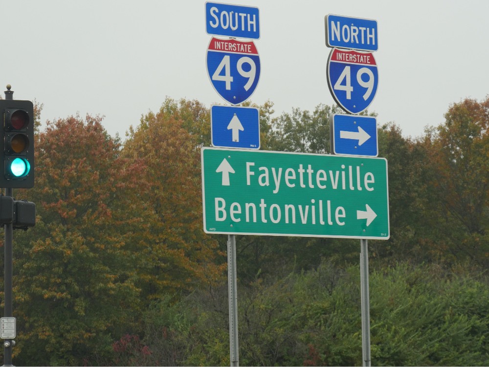 Roadside signs for Fayetteville and Bentonville