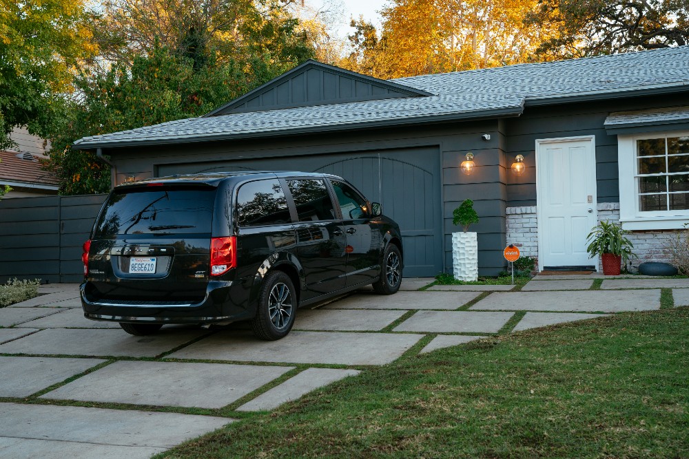 Car in driveway watched over by the Vivint Outdoor Camera Pro.