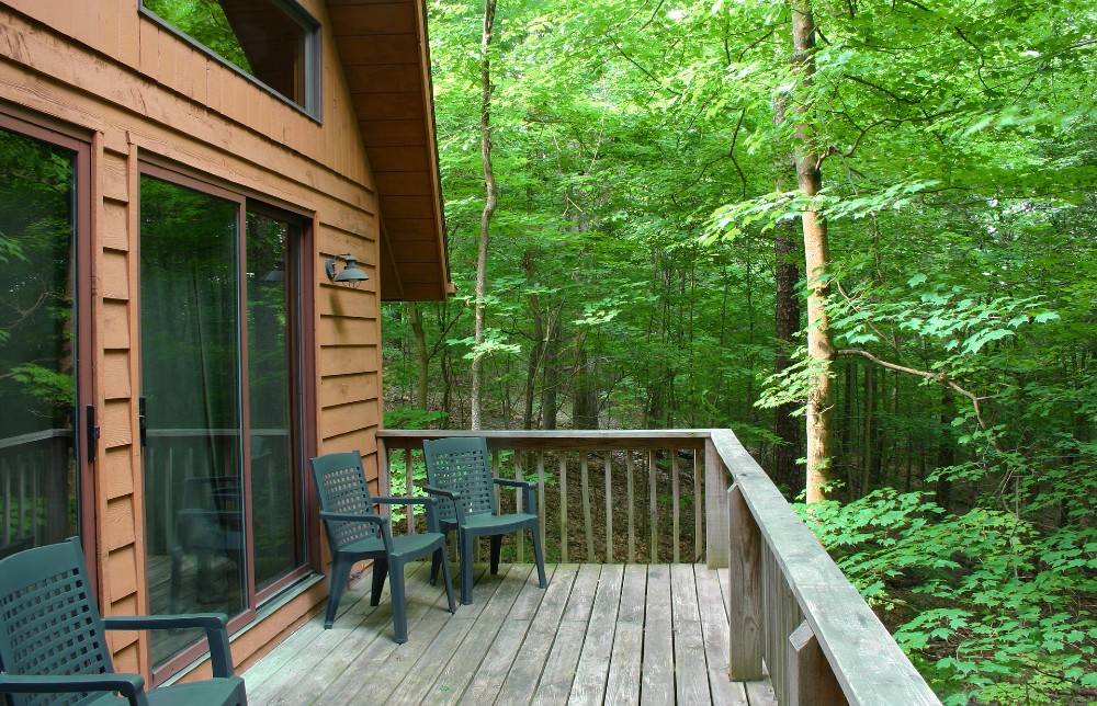 Sliding glass door on a cabin in the woods.