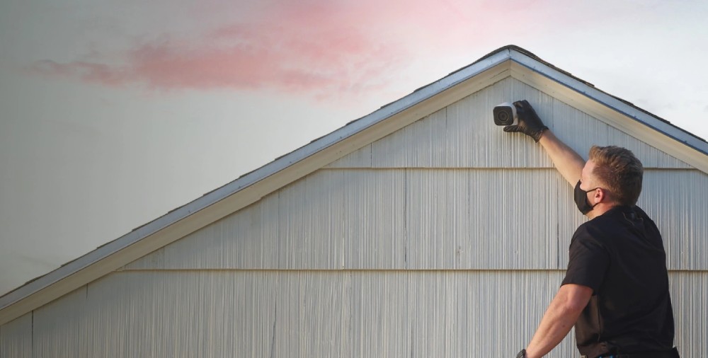 Vivint Smart Home Pro installing an outdoor security camera.