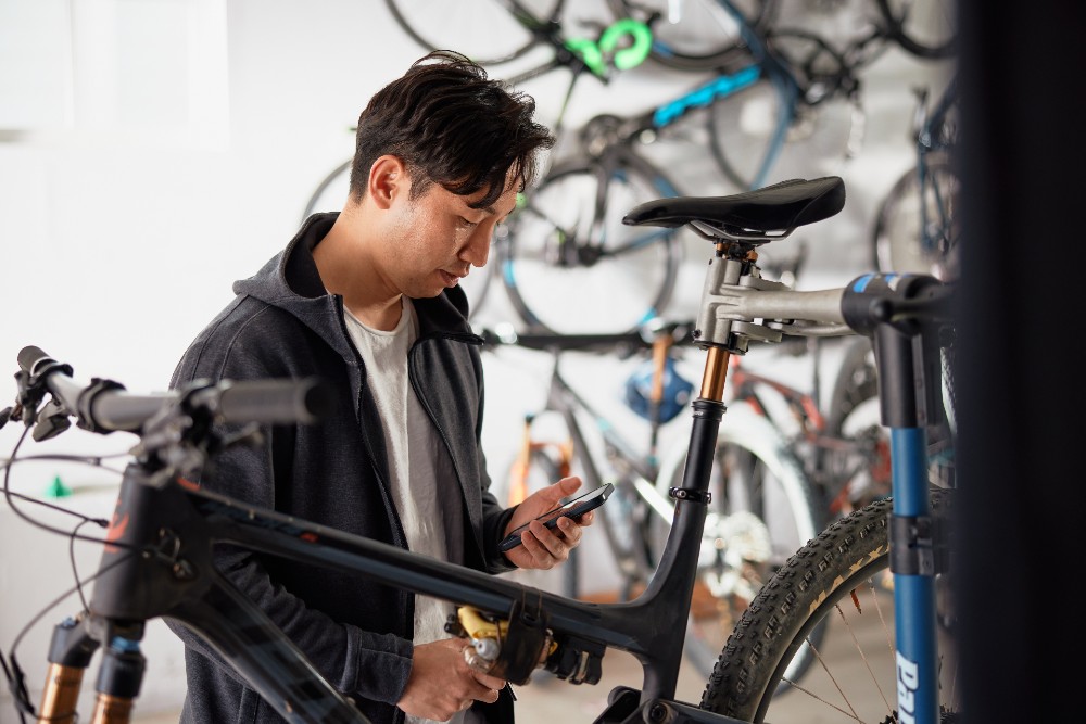 Man checking his phone in his garage.