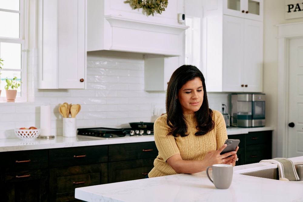 Woman researching smart home information on her phone.