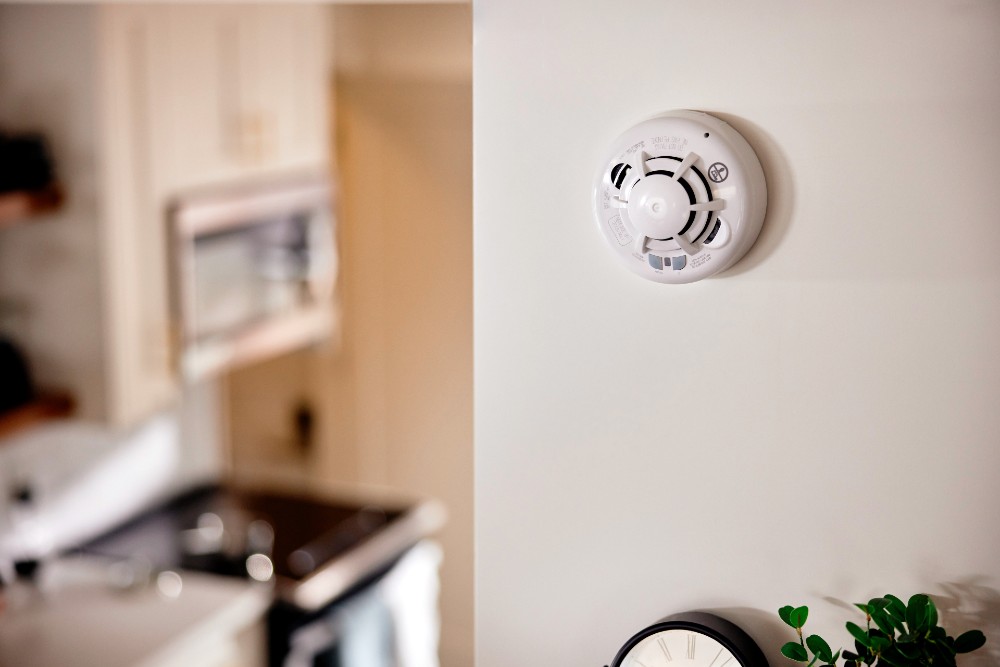 Combo Smoke and CO Detector from Vivint on a wall.