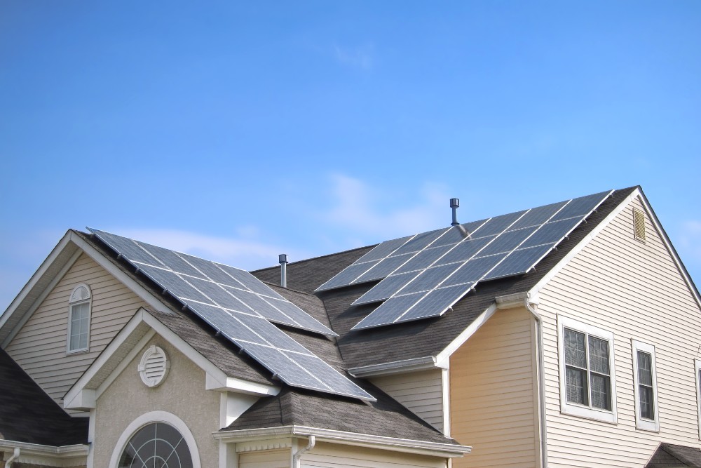 A single-family home with solar panels installed on the roof.