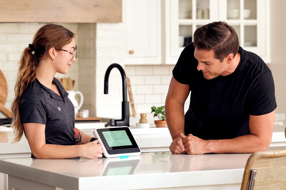 Home security tech sitting with a vacation rental home host.