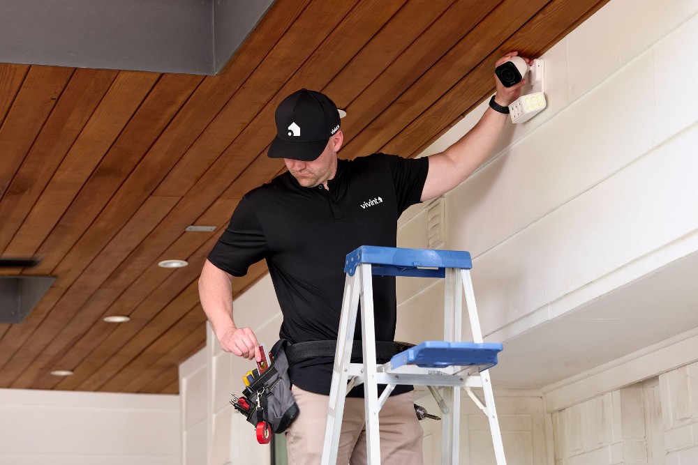 Vivint Installation Professional setting up a home security system.