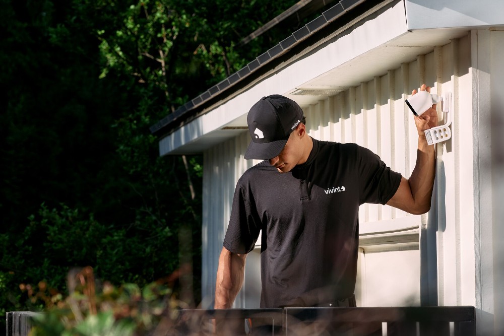 Vivint tech installing a Spotlight Pro floodlight camera.