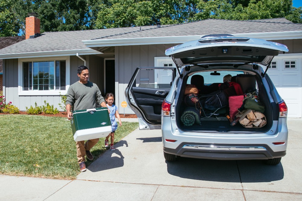 Family loading up the car for a camping trip.