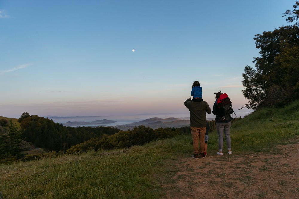Family at a lookout point on a hike.