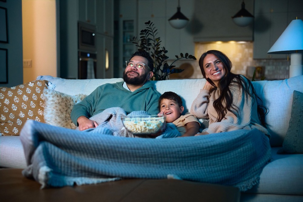 Family watching a movie together.