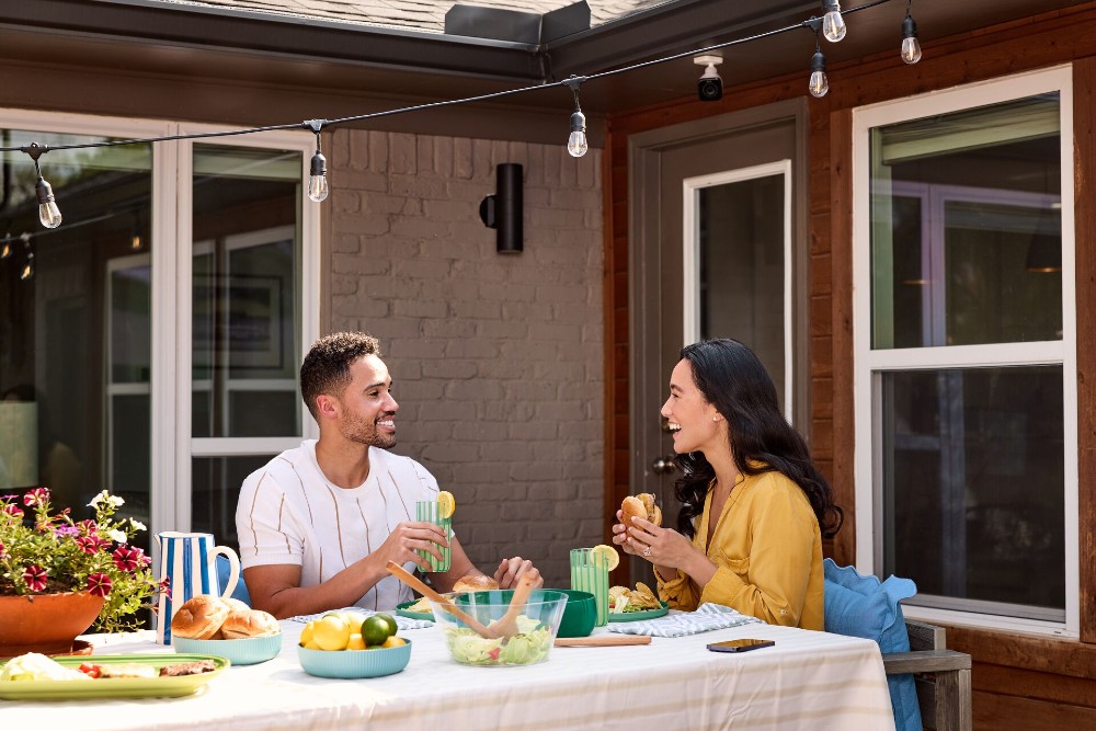 Couple eating in the back yard.