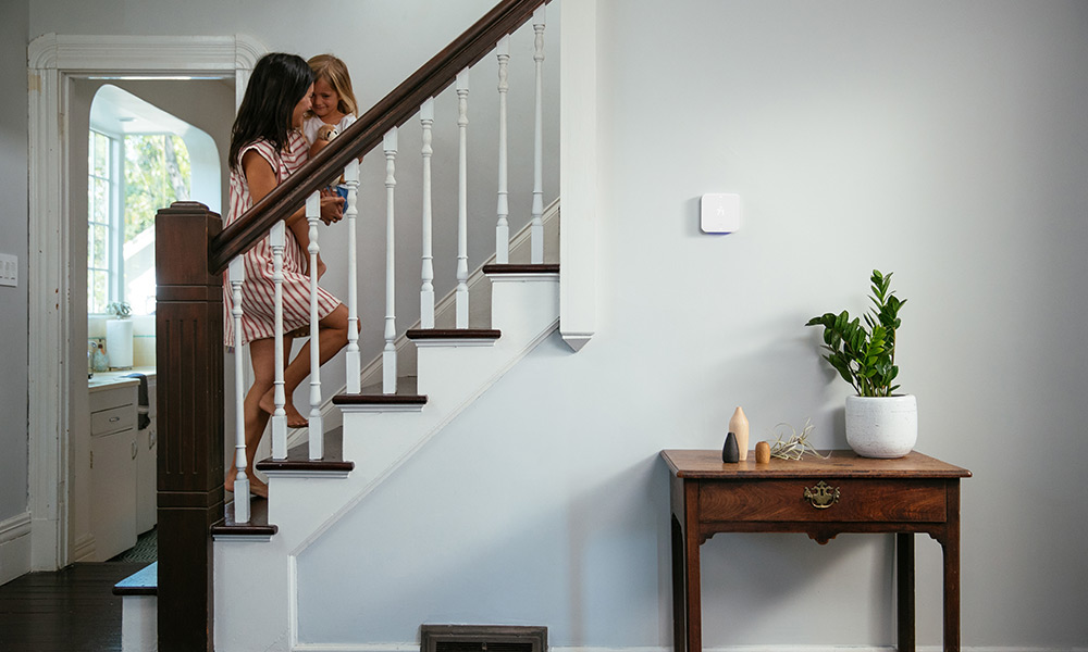 Woman carrying child up stairs