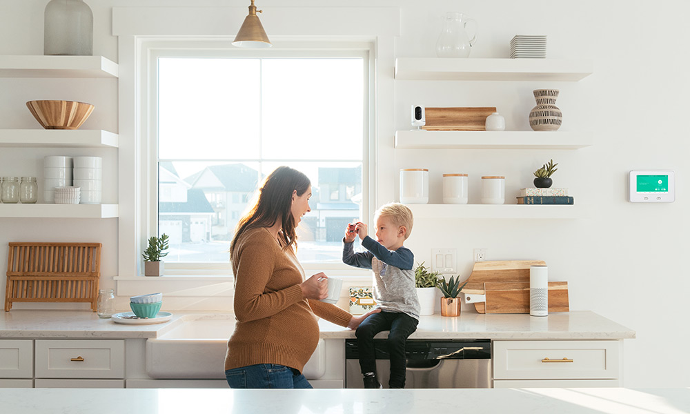 Mom and son in kitchen with Vivint indoor camera camera