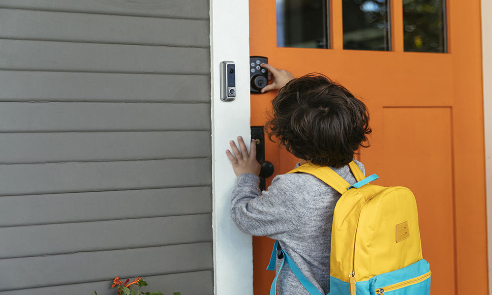 boy with Vivint doorbell camera and door lock 