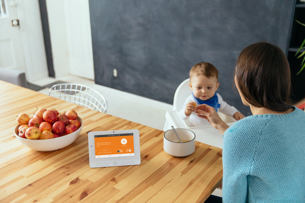 Vivint Hub in the kitchen with mom and baby