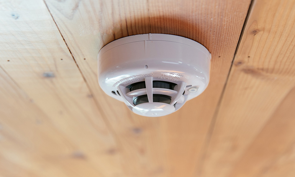 Smoke detector mounted on a wood ceiling