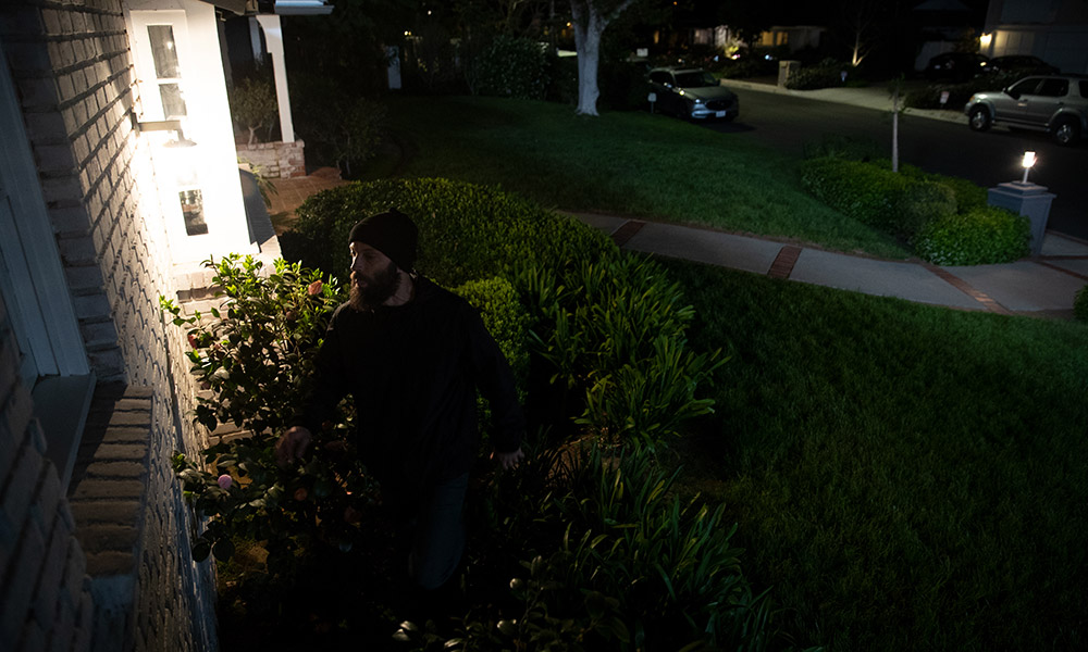 burglar in front of a house