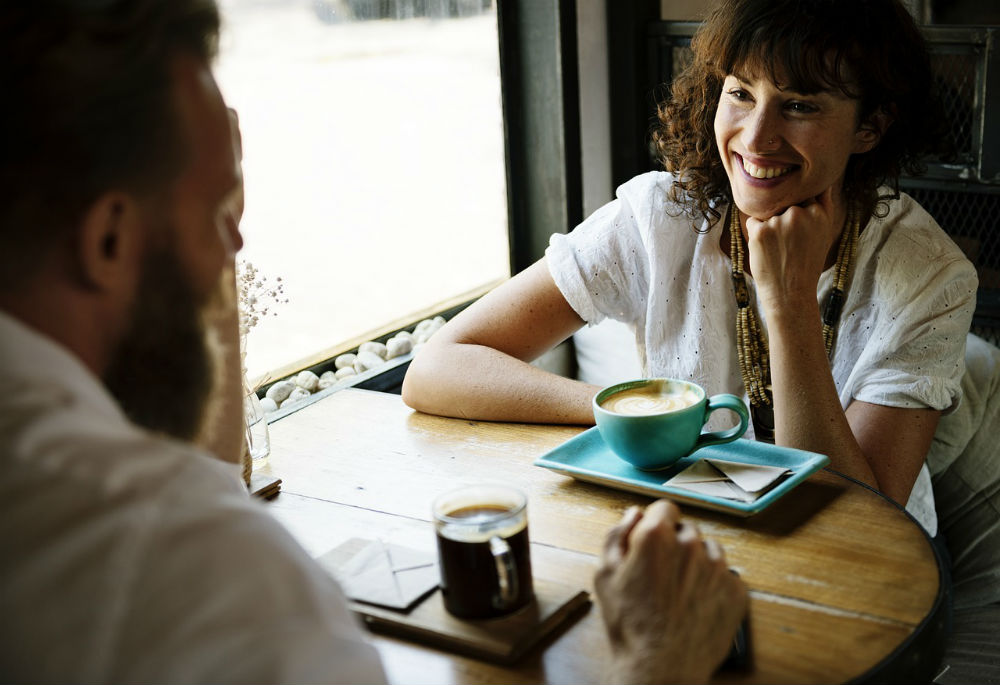 Woman and man talking over coffee