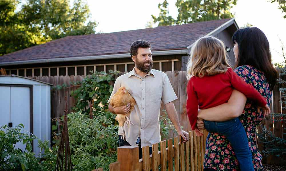 Neighbors talking over a fence