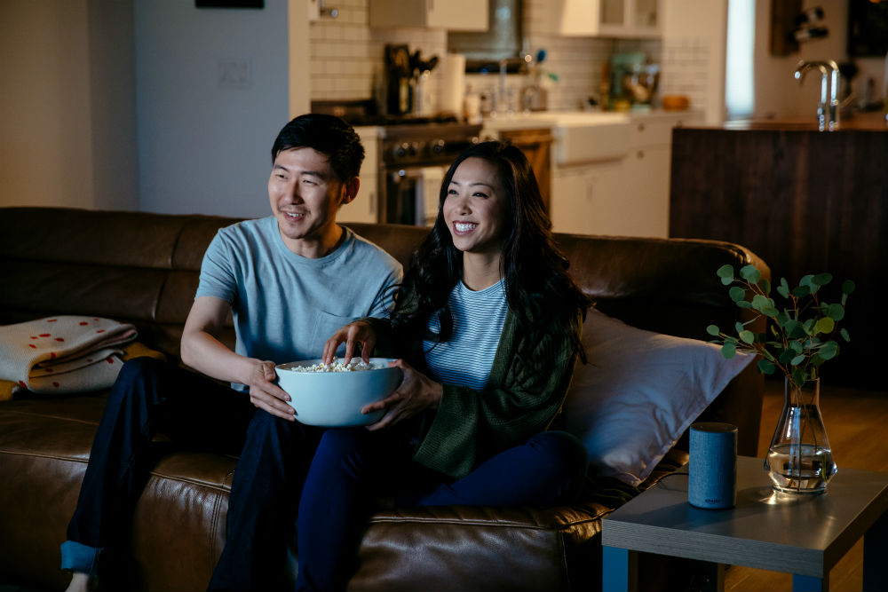 couple watching movie on couch