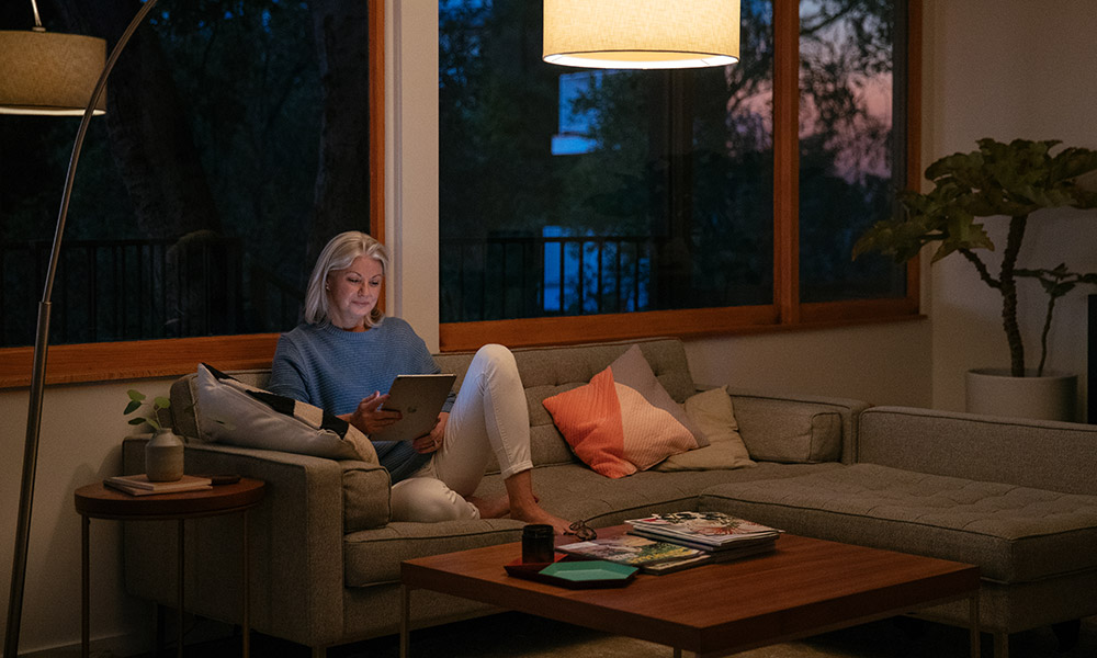 Women reading a tablet on a couch in the living room