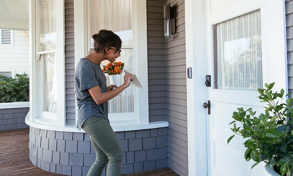 Lady interacting with a Vivint doorbell camera