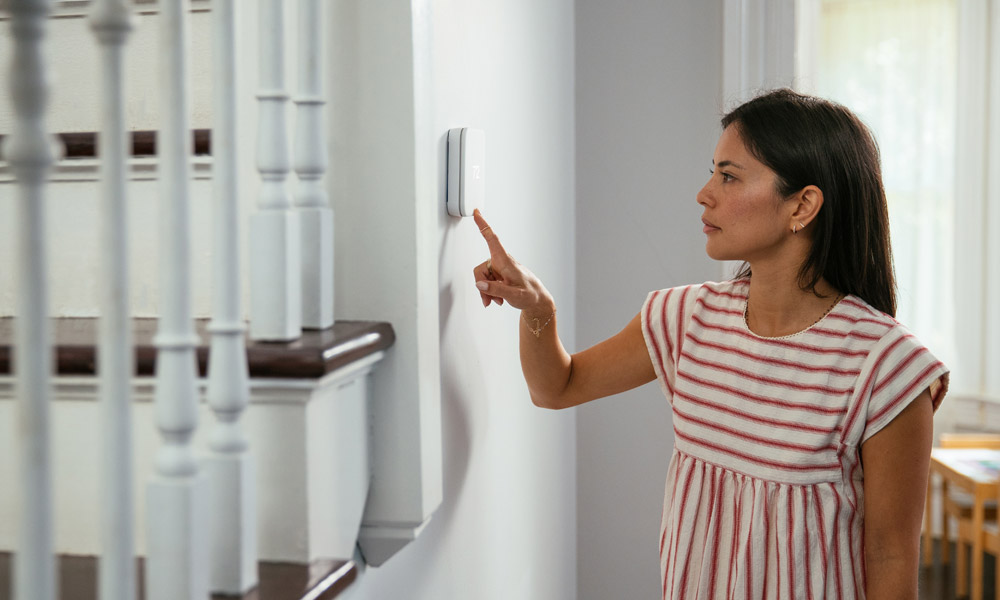 Vivint Smart Thermostat Woman Adjust Touch