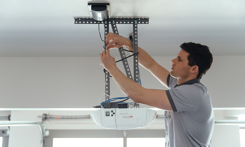 How do you install a tilt sensor on a garage door?