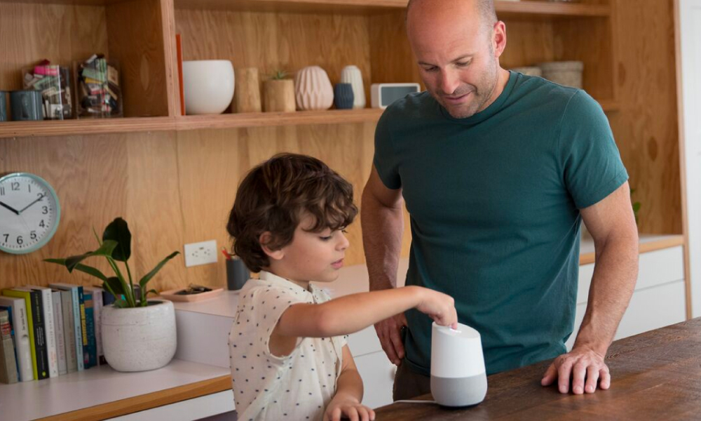 Dad and son using a Google Home