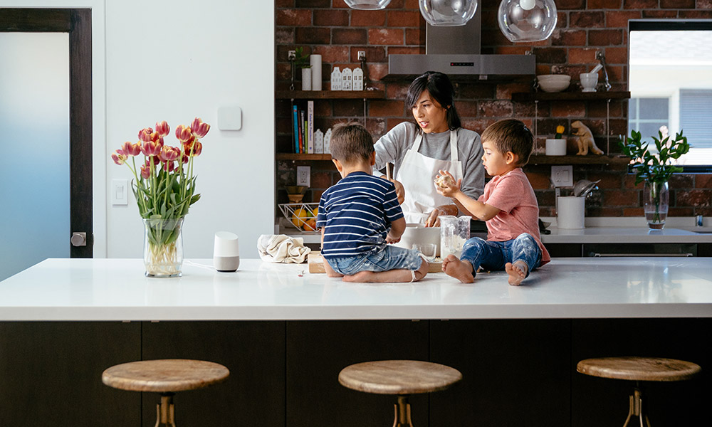 mom speaking to Google Home in the kitchen