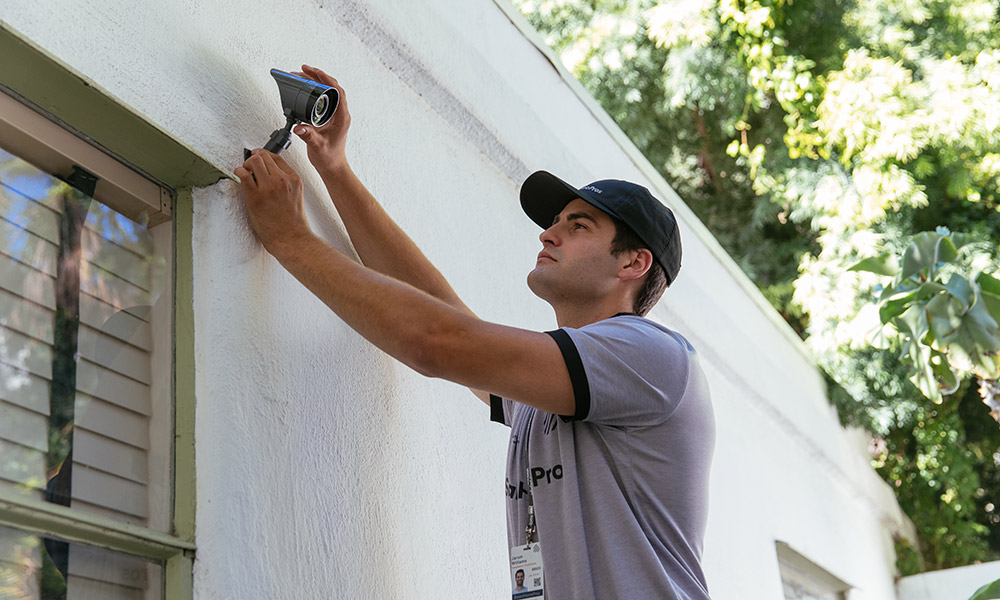 Vivint professional installing an outdoor camera